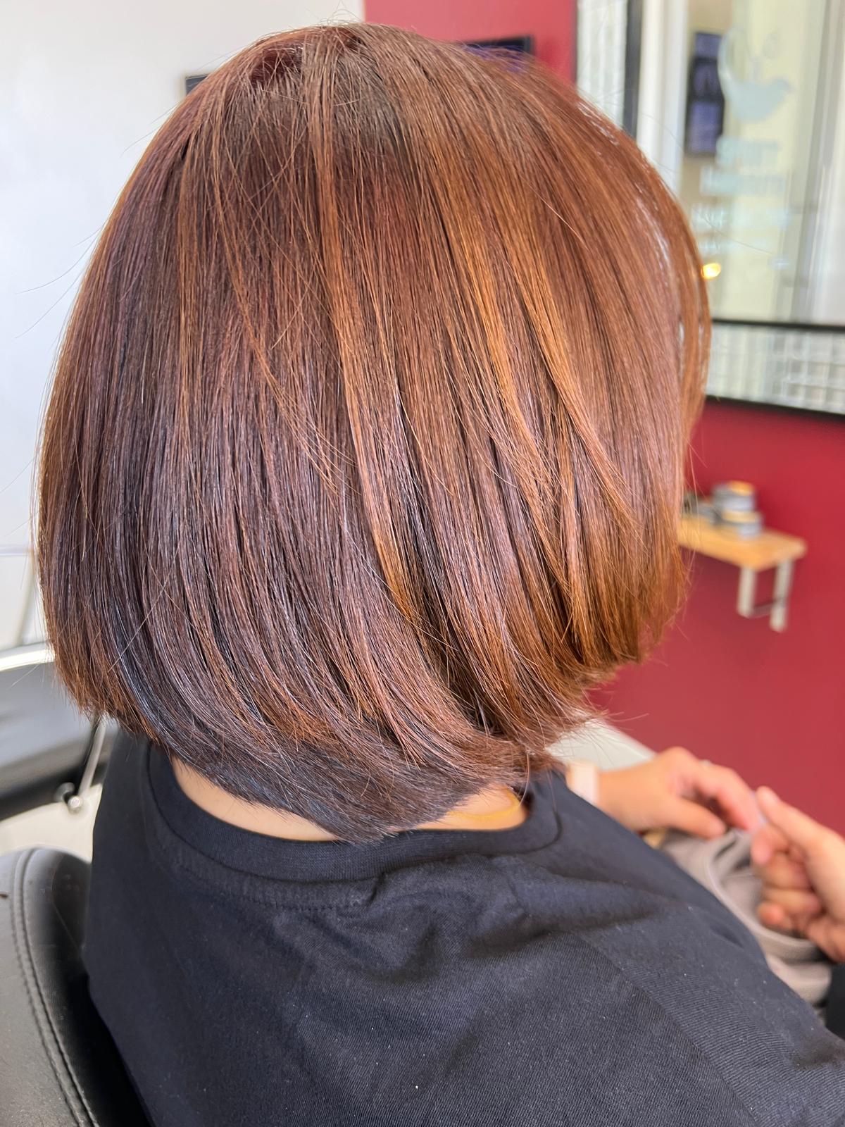 Copper color bob haircut finished at the salon
