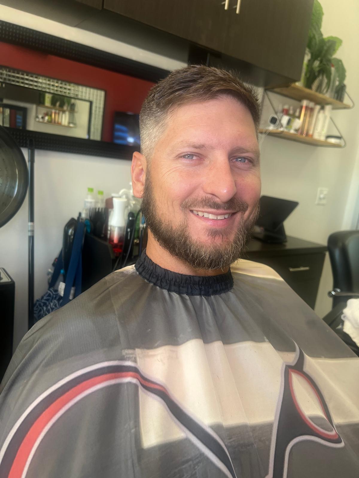 Smiling client with a neatly trimmed beard